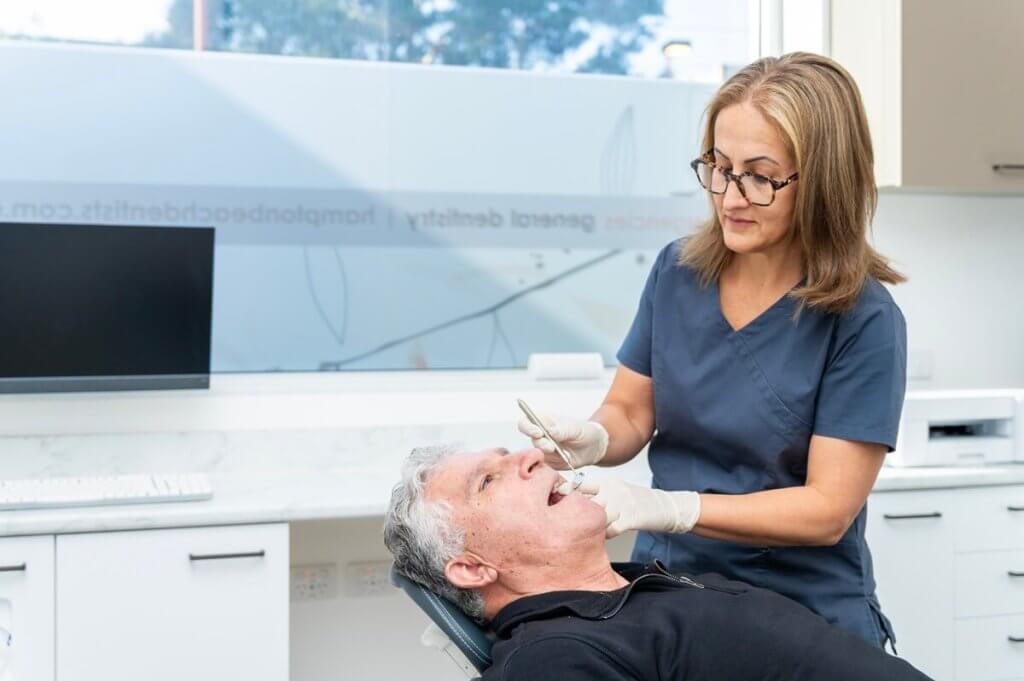 Man undergoing oral cancer screening at dentist