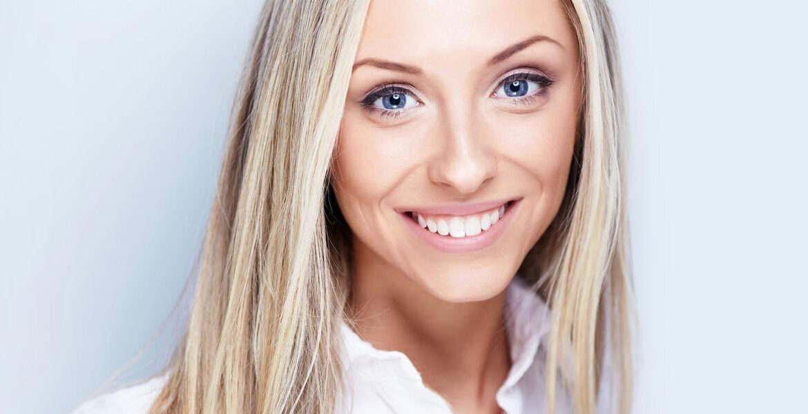 Woman who has received take-home teeth whitening treatment